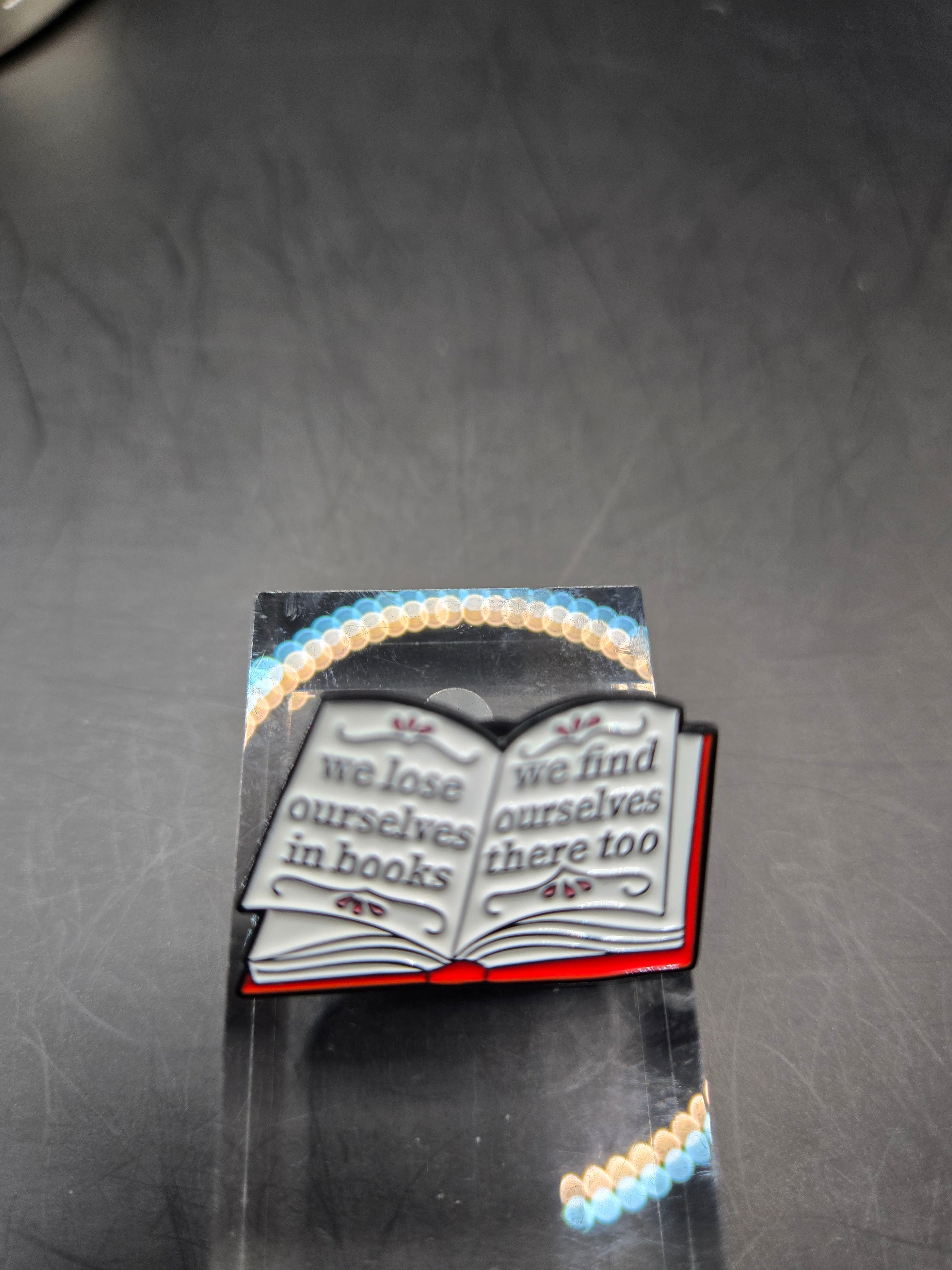 We Lose Ourselves In Books Pin