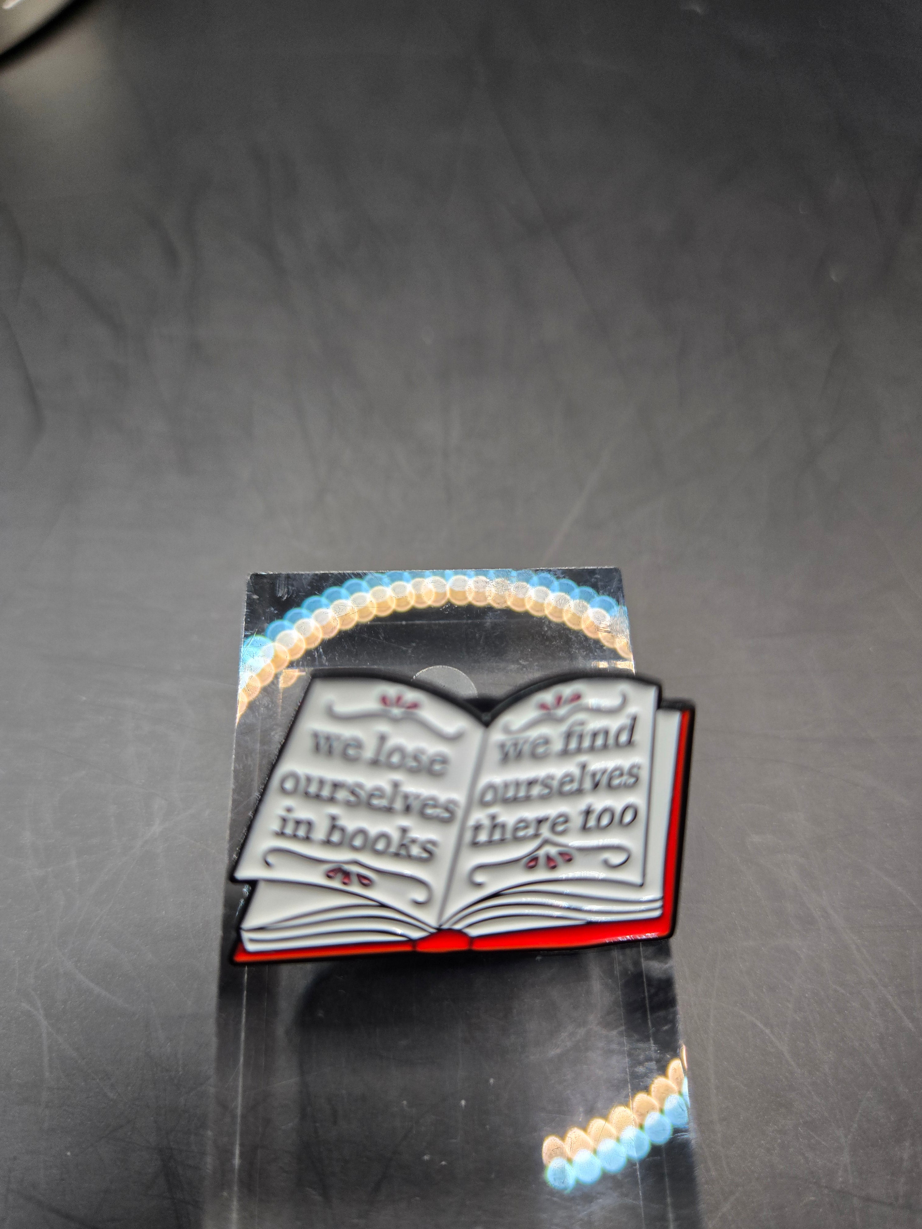 We Lose Ourselves In Books Pin